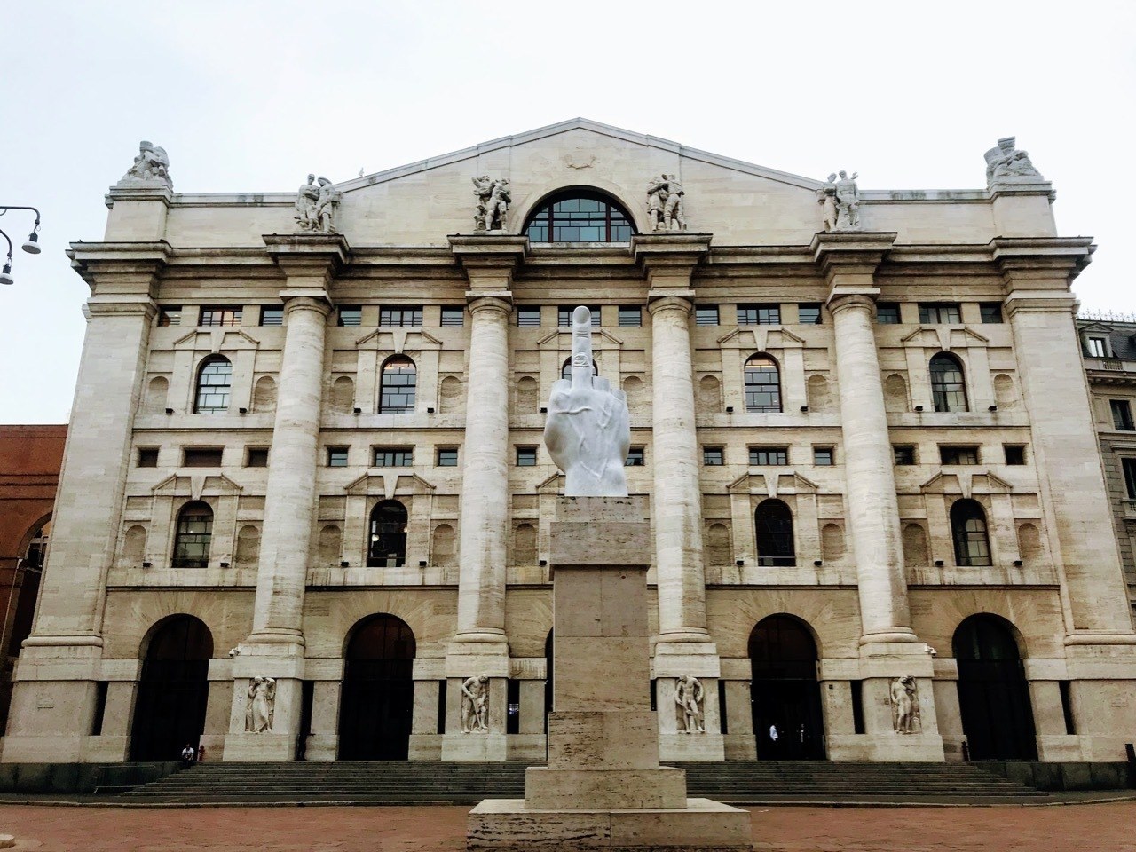 Milan Stock Exchange with hand showing middle finger