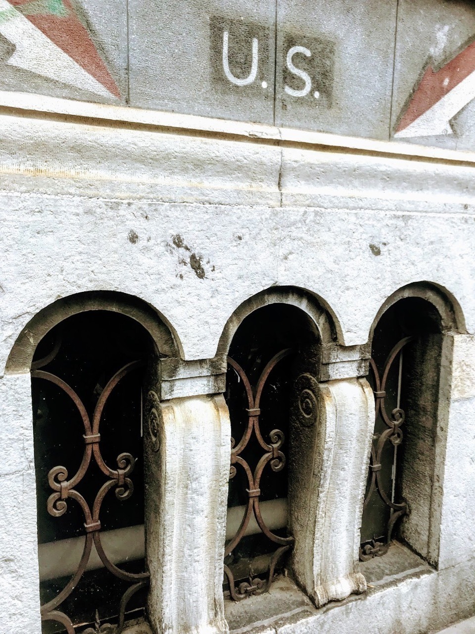 US sign above a basement grille in Milan