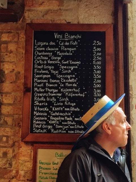 gondola driver in Venice bar next to wine list