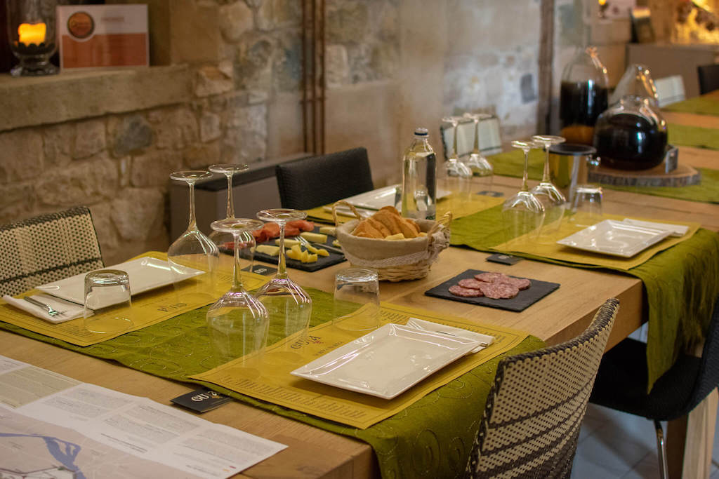 Guia tasting table with wine glasses and food