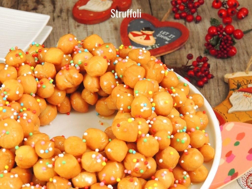 wreath shaped honey sweet pastries on a festive plate