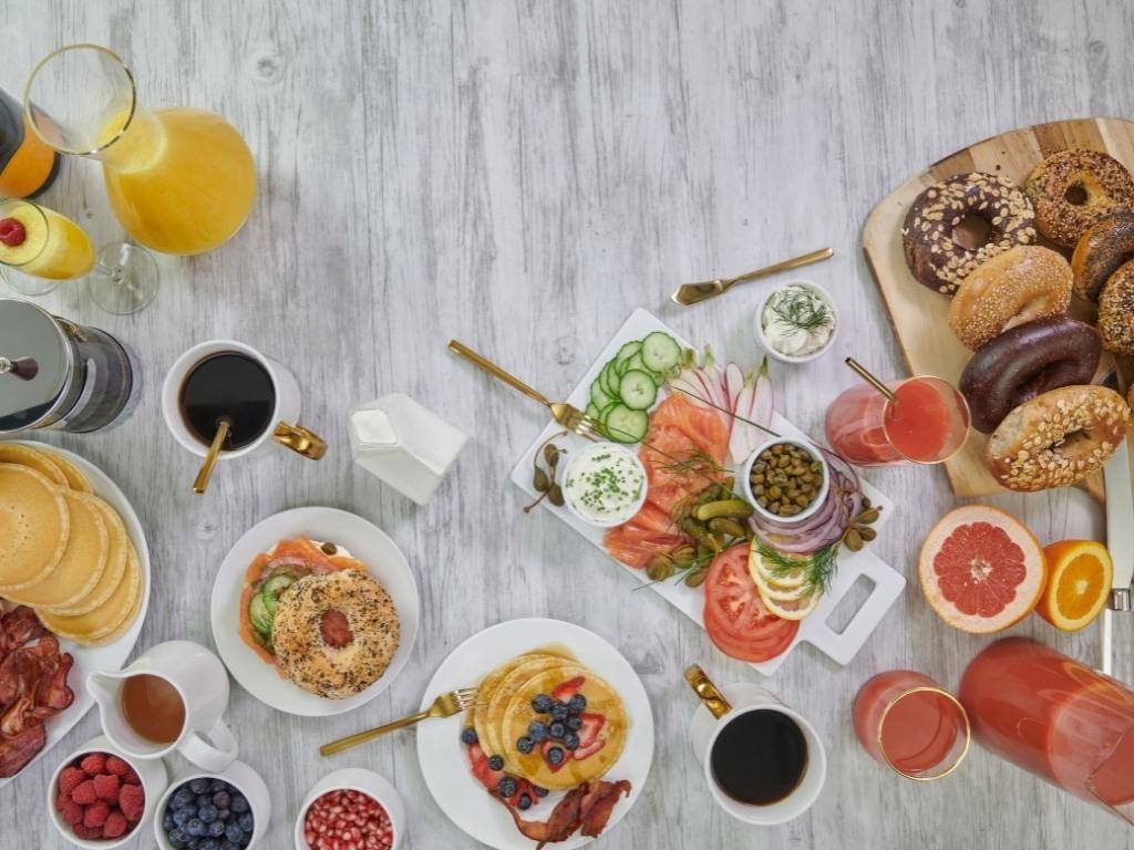 table with brunch items, mimosa and coffee