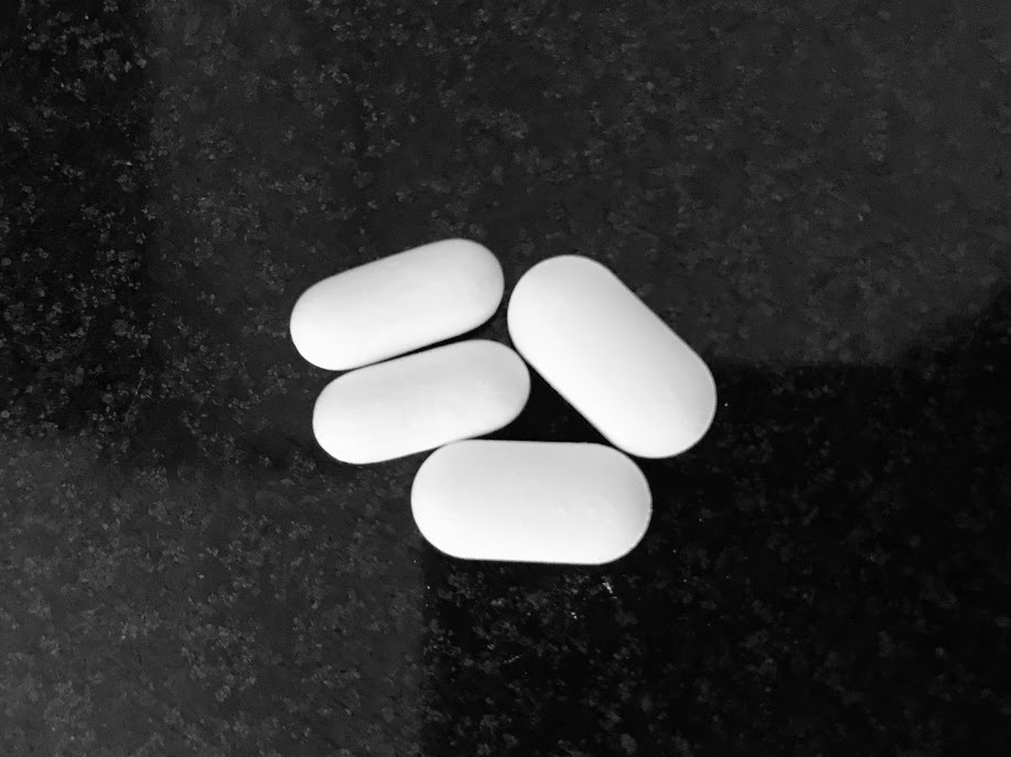 white pills on a black counter