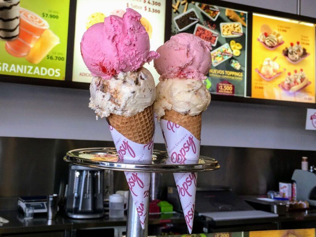 strawberry and vanilla double scoop ice creams in a cone