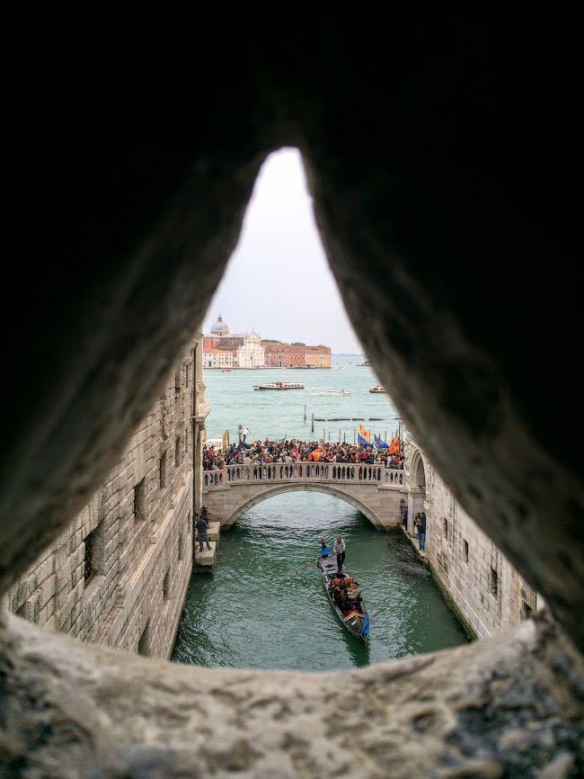 View out across Venice from small hole within Bridge of Sighs corridor