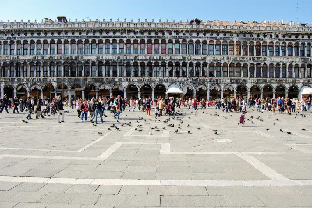 St Marks Square with people and pigoens in Venice