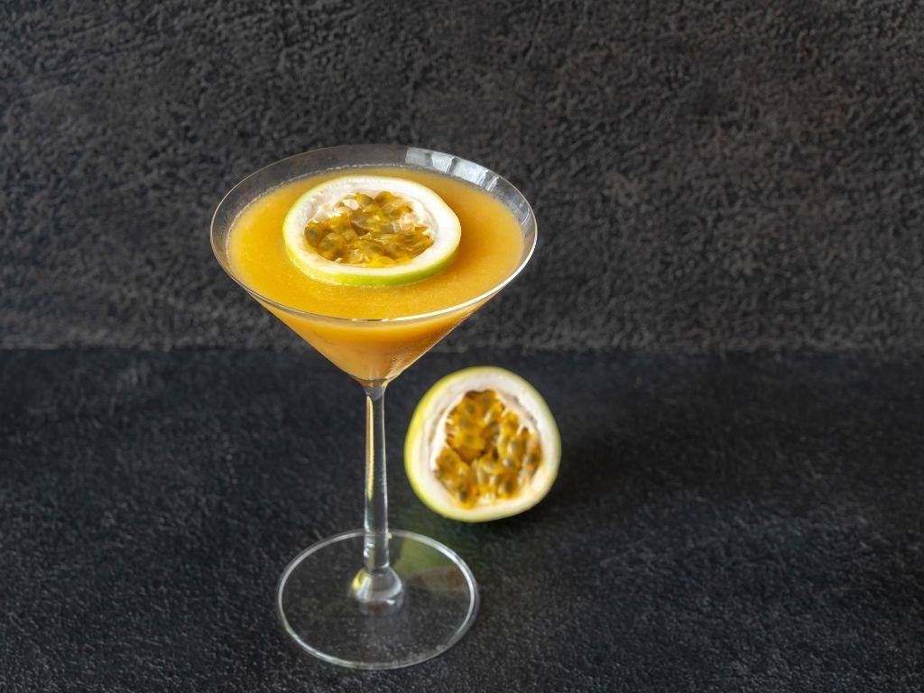 close up of martini with passionfruit garnish