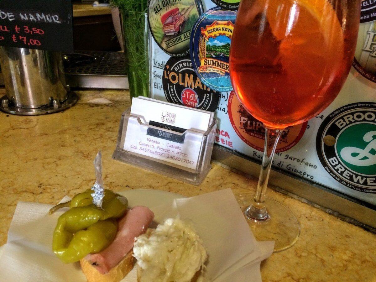 Aperol spritz and cichetti small sandwiches in a bar in Venice