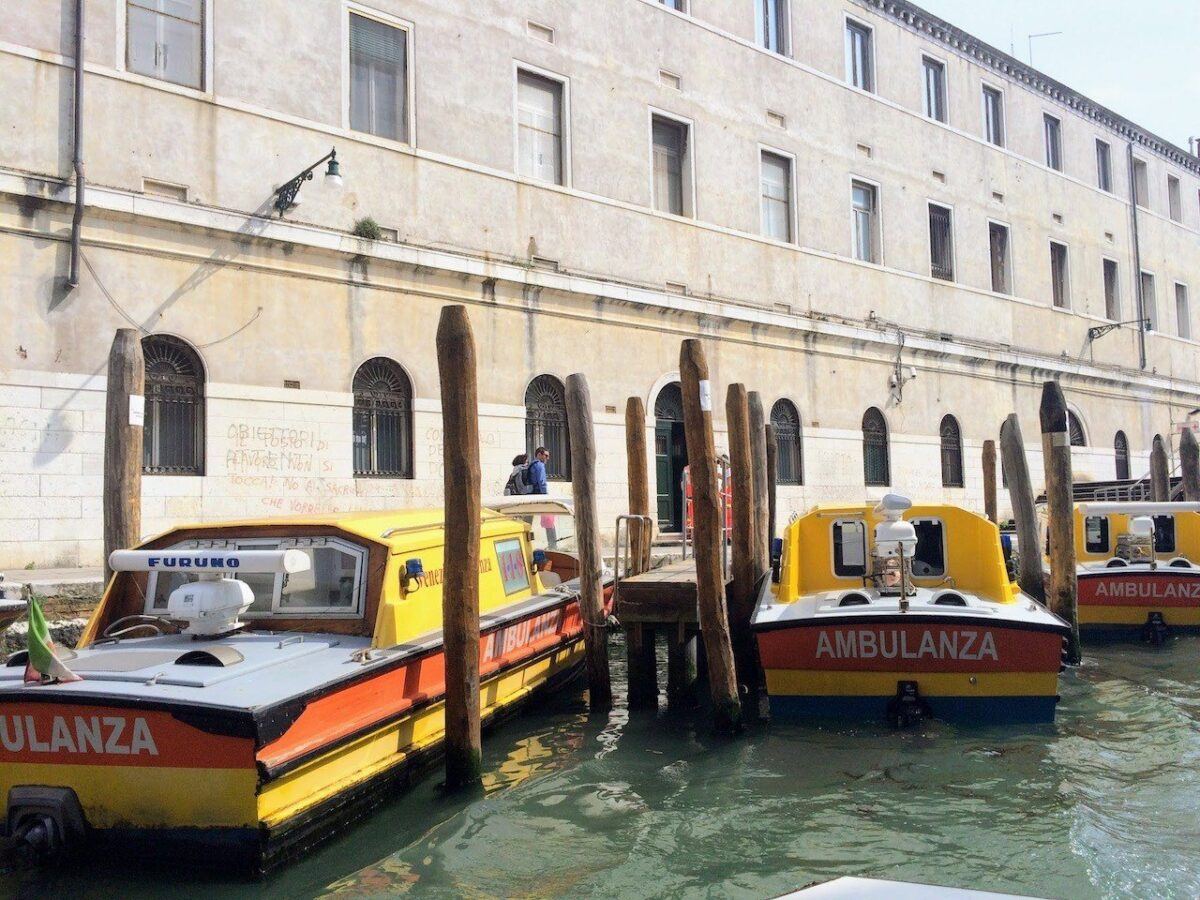 Yellow Ambulance boats in a mooring bay in Venice 