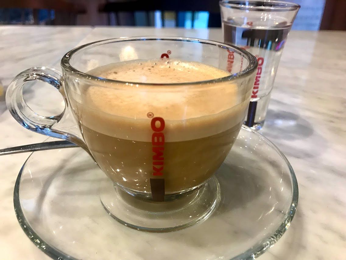 Espresso with milk and glass of water