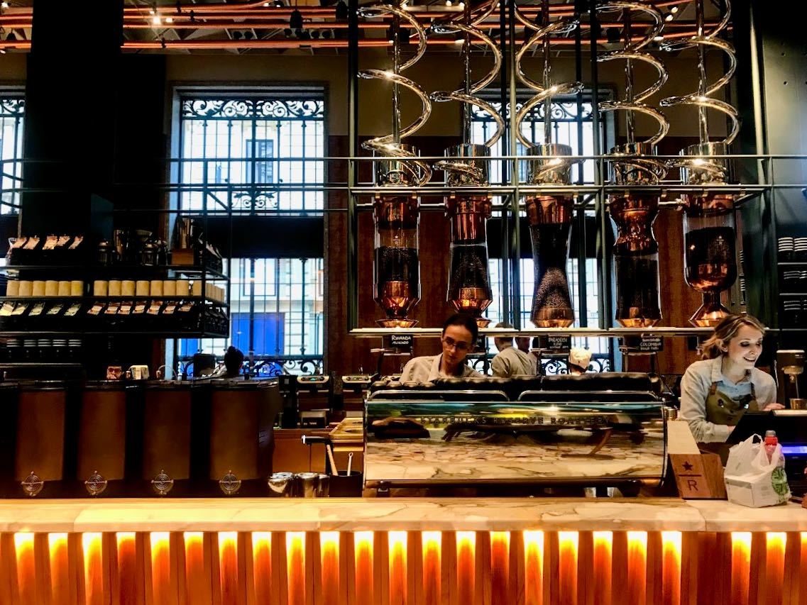 Inside first starbucks in Milan coffee machine and baristas