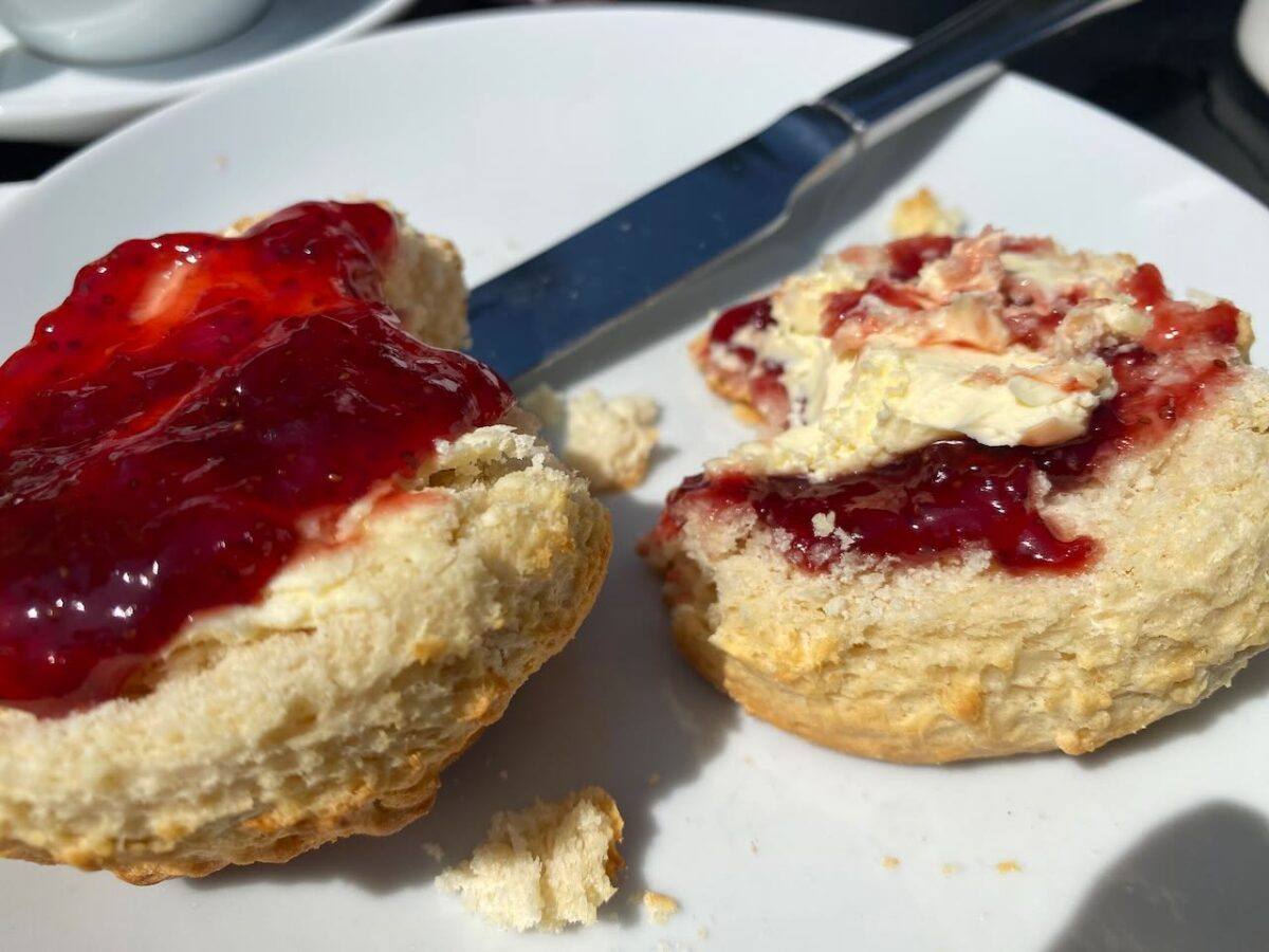 Scones with jam on a plate.